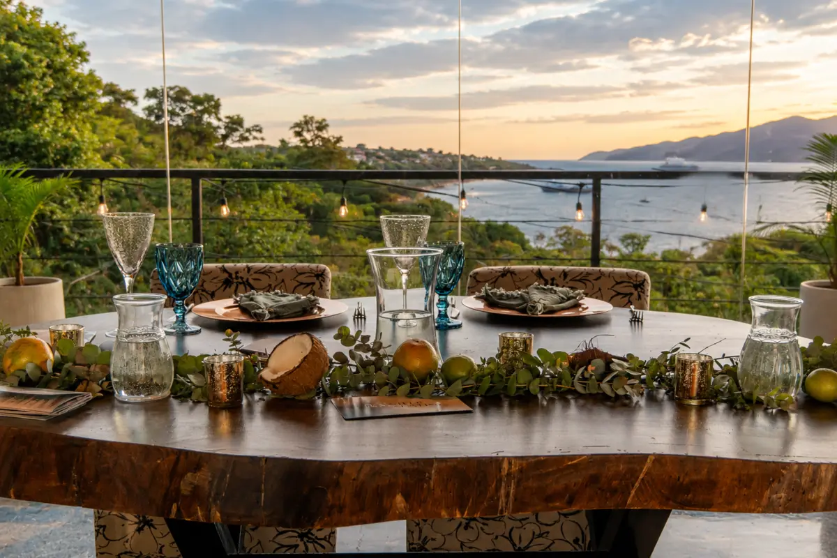 A long reception table set in gold and white as the sun sets over the Pacific.